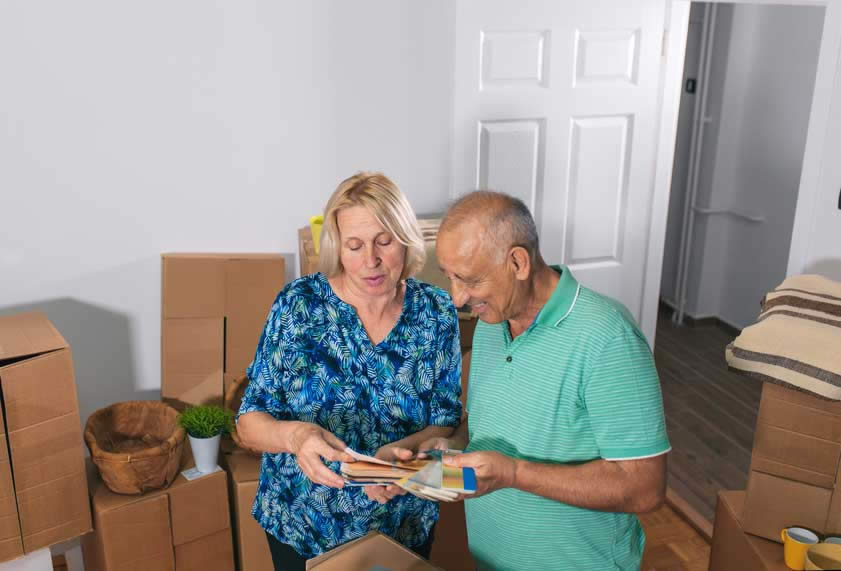couple looking at colour charts for new house